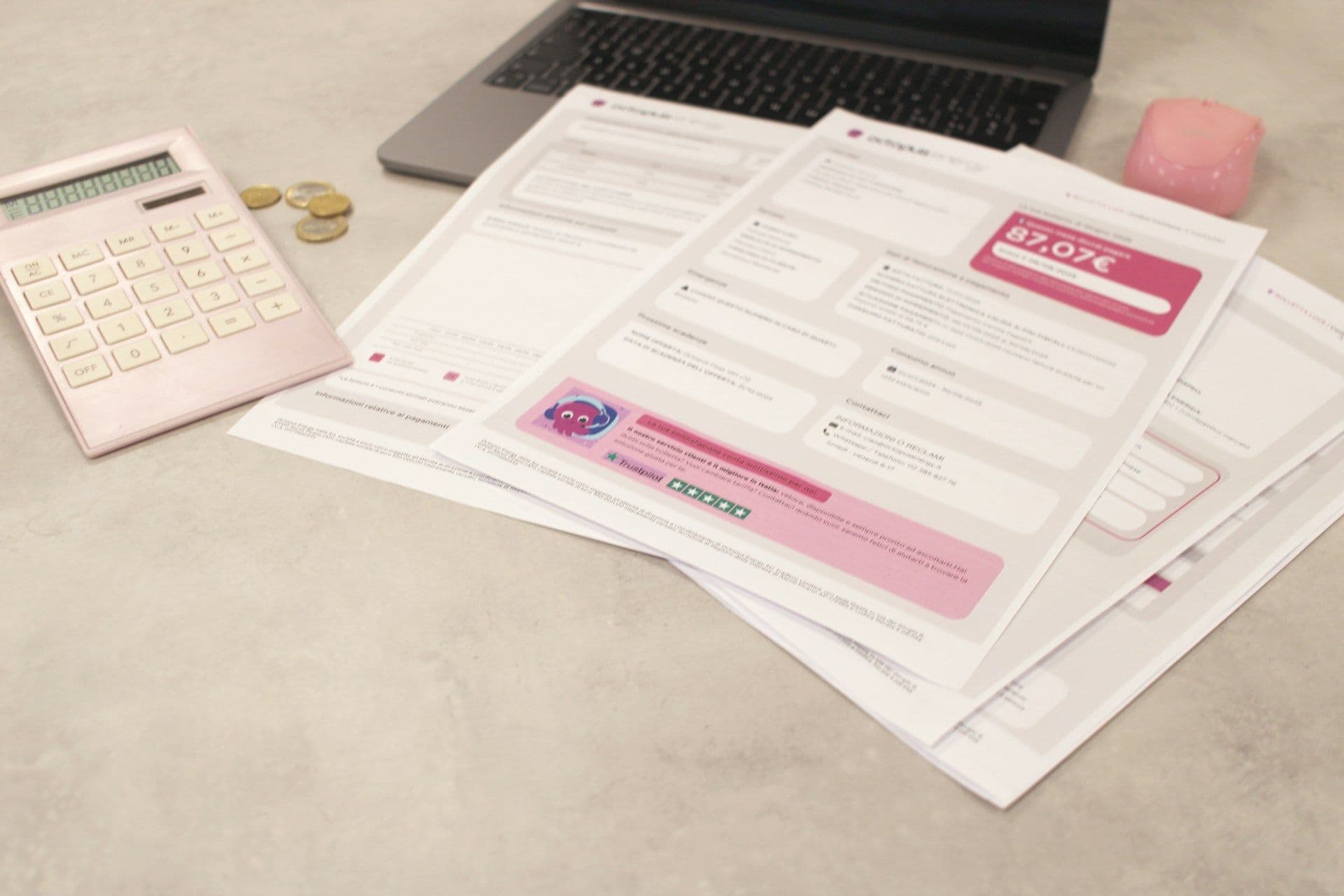 Bank statements and a calculator on a desk during a monthly bank feed reconciliation